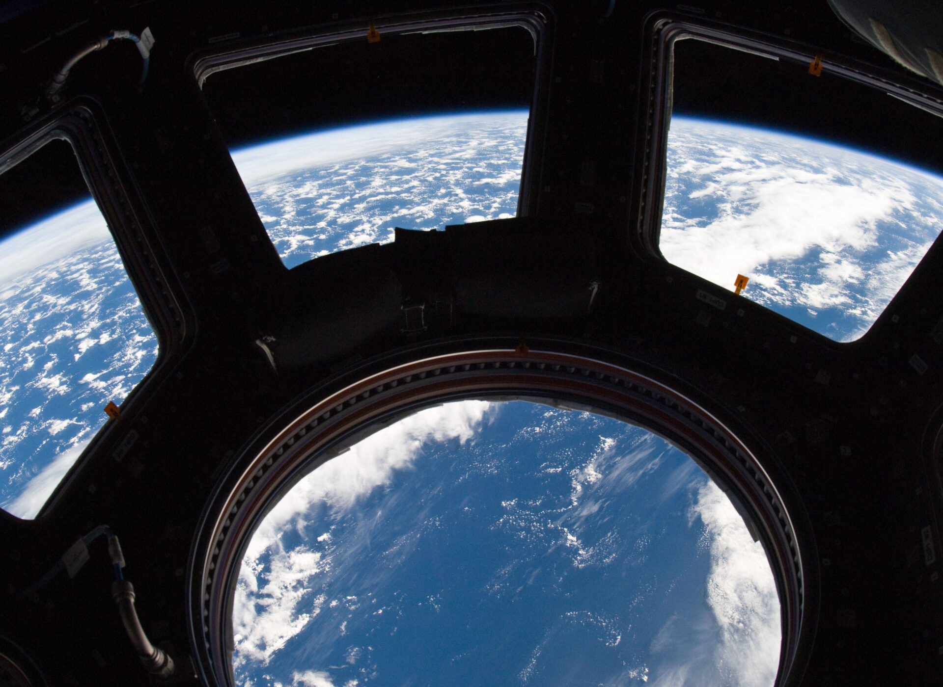 A blue and white part of Earth and its horizon, as seen through the windows in the Cupola, are featured in this image photographed by an Expedition 22 crew member on the International Space Station. NASA photo ISS022-E-080014