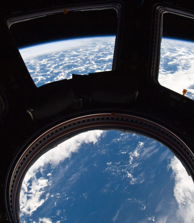 A blue and white part of Earth and its horizon, as seen through the windows in the Cupola, are featured in this image photographed by an Expedition 22 crew member on the International Space Station. NASA photo ISS022-E-080014