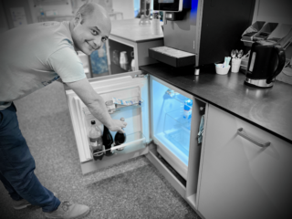 ISSI Secretary Dominique Fuchs getting the good stuff out of the fridge in ISSI’s common social area to prepare celebration of the new webpage release.