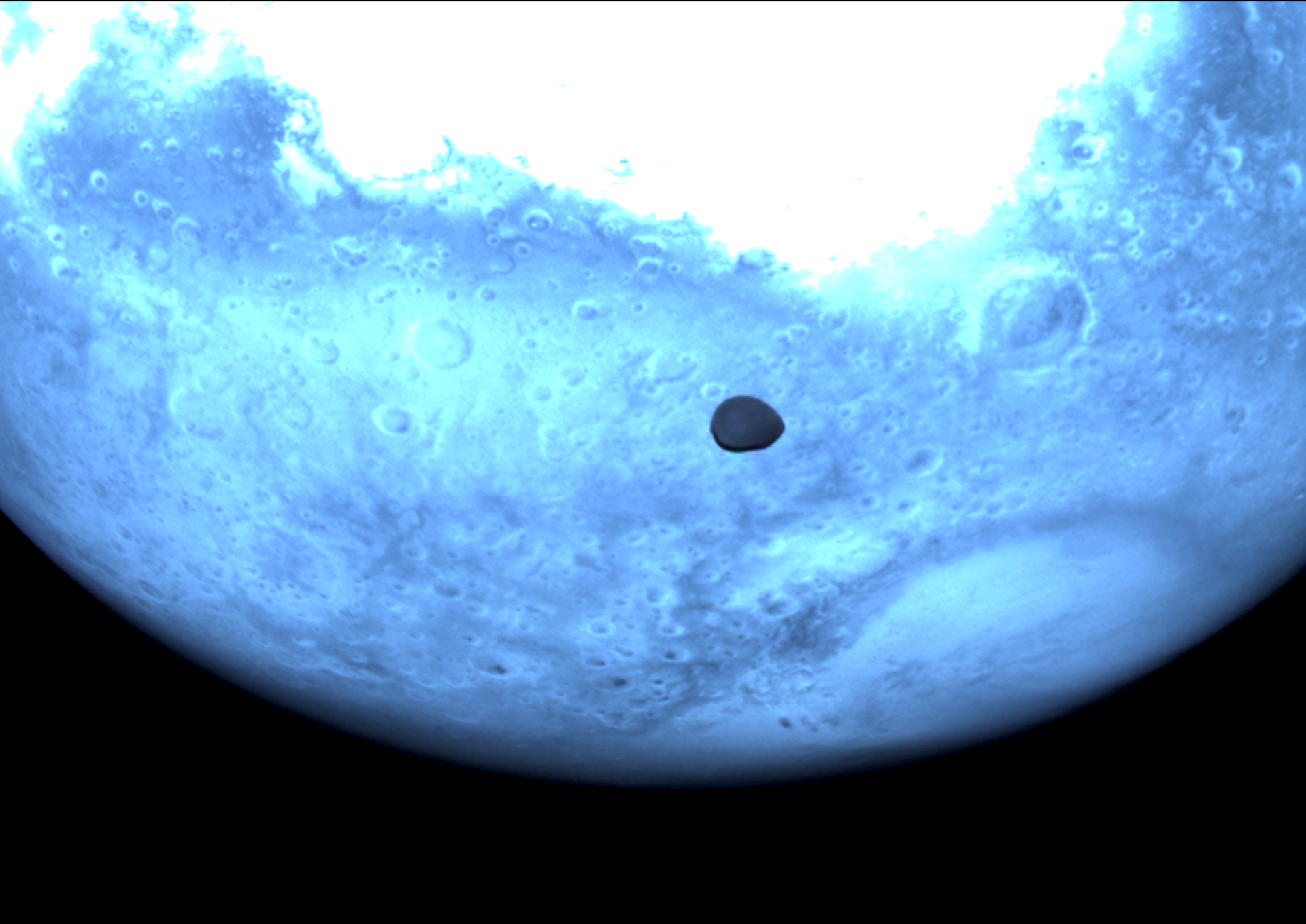 Mars and Deimos viewed by Hera's Hyperscout H. The red planet appears light blue in this near-infrared Hyperscout H image from ESA’s Hera spacecraft. credit: ESA