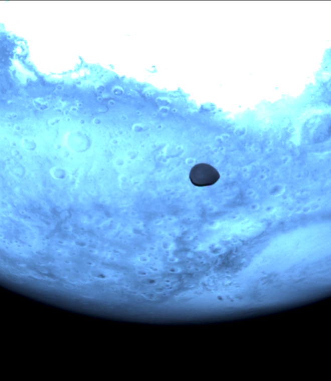 Mars and Deimos viewed by Hera's Hyperscout H. The red planet appears light blue in this near-infrared Hyperscout H image from ESA’s Hera spacecraft. credit: ESA