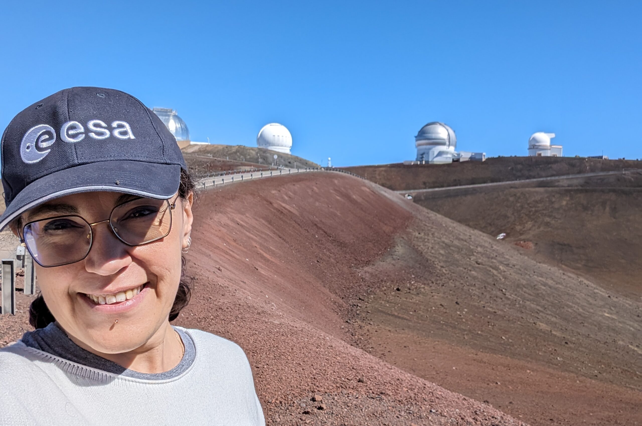 Elena Sabbi in front of the Mauna Kea Observatory on the Big Island of Hawaii